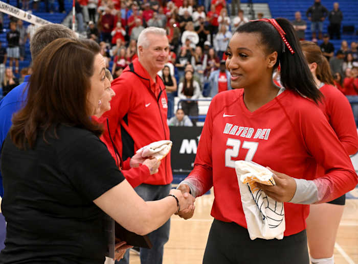 Isabel Clark (27), shown here accepting congratulations for winning the Southern Section championship on Nov. 4, had another big match on Tuesday, helping the Monarchs to the Southern California Open title.